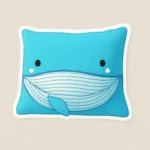 Custom puffy sticker mockup from PuffSticker.com featuring a blue whale pillow character with a rectangular shape and white trim. The design includes expressive black eyes, blushing white cheeks, and a wide striped mouth that adds playful charm. Inspired by whimsical plush decor, this sticker evokes a soft, ocean-themed aesthetic—perfect for children’s gifts, marine branding, or cozy packaging. Printed on raised EVA foam with a glossy finish, it’s durable, peelable, and irresistibly cute. Ideal for sticker sheets, journaling, or promotional bundles with a sea-life twist.