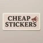 Rectangular vinyl sticker with rounded corners featuring the phrase “CHEAP STICKERS” in bold black capital letters on a beige background. Accompanied by a brown megaphone illustration emitting sound lines to emphasize loud, budget-friendly messaging. Printed with durable adhesive on waterproof vinyl for promotional use, designed by puffsticker.com to make sticker pricing stand out with humor and impact.