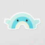 A 3D label designed as a fluffy rainbow-shaped stuffed toy with a soft, puffy texture, built with a sticky backing, foam-filled vinyl base, and resin-coated top for durability. This waterproof sticker is great for creative projects or giveaways, customizable with designs, and available from PuffSticker.com.