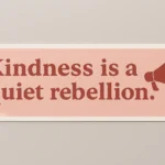 Rectangular vinyl bumper sticker featuring the phrase “Kindness is a quiet rebellion” in bold dark red serif typography against a light pink background. Includes matching megaphone illustration emitting sound lines to the right of the text. Printed by PuffSticker.com to amplify compassionate messaging through minimalist activist design. Ideal for laptops, notebooks, and cause-driven merchandise.