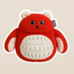 Custom puffy sticker mockup from PuffSticker.com featuring a red plush character with a round body, white belly, and stitched facial details. Inspired by GUND-style plush toys, this design includes black button-like eyes, a small stitched nose, and whisker-like accents. The white inner ears and hands add contrast, while the stitched belly pattern enhances its handmade charm. Printed on soft EVA foam with a raised 3D texture, this sticker is ideal for toy branding, children’s gifts, or kawaii-themed packaging. Durable, peelable, and irresistibly cute—perfect for playful promotions.